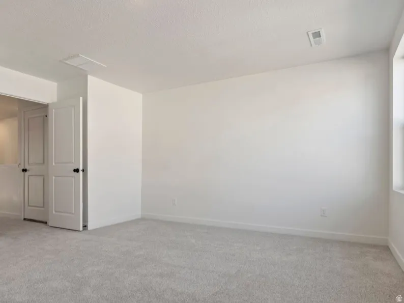 Bright interior space with light gray carpeting and white walls