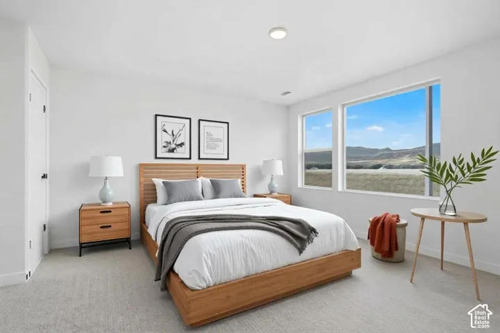 Neutral-toned interior featuring wall-to-wall carpeting, expansive windows, and a scenic mountain backdrop