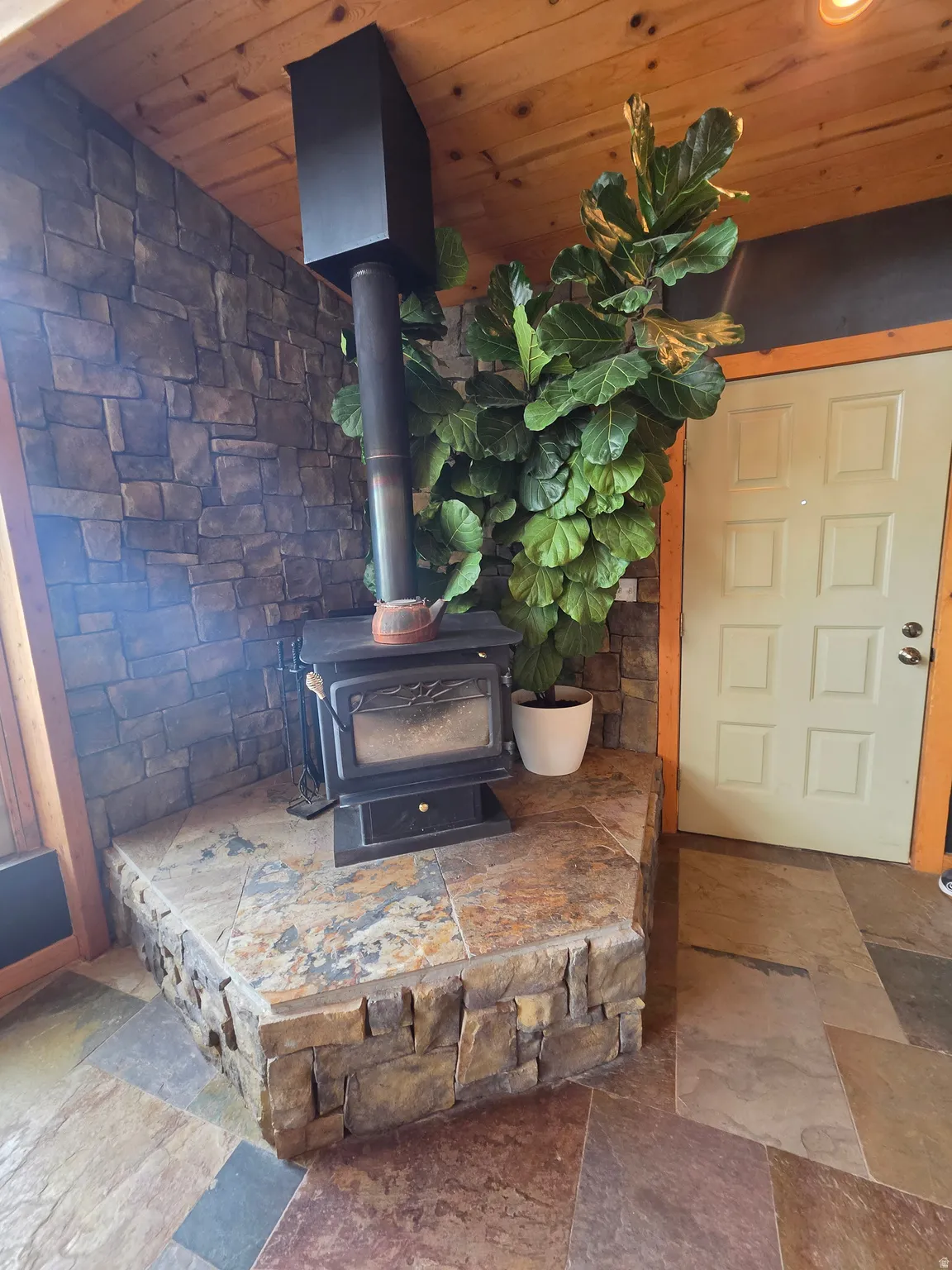 Wood-burning stove with a stone surround and hearth