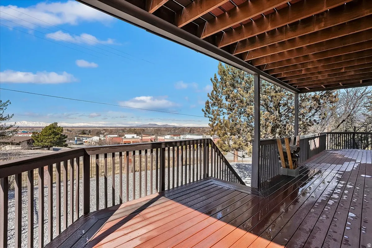 Spacious wood-finish deck with dark railings and open risers