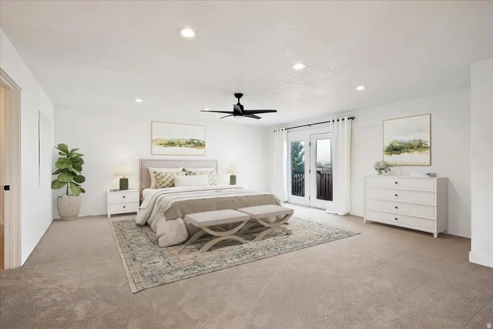 Spacious room featuring neutral carpeting, recessed lighting, and a modern ceiling fan
