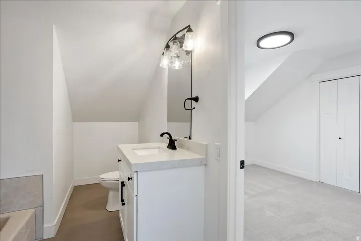 Bathroom vanity with a white countertop and a matte black faucet