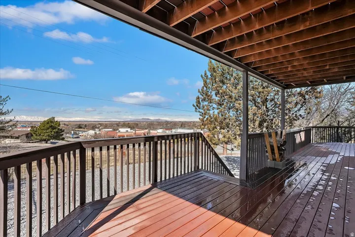 Spacious wood-finish deck with dark railings and open risers