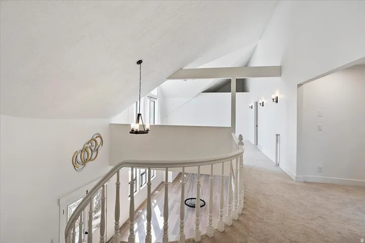 Curved staircase with white spindle railing