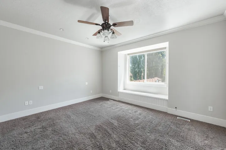 Spacious room with plush carpeting and a large window seat