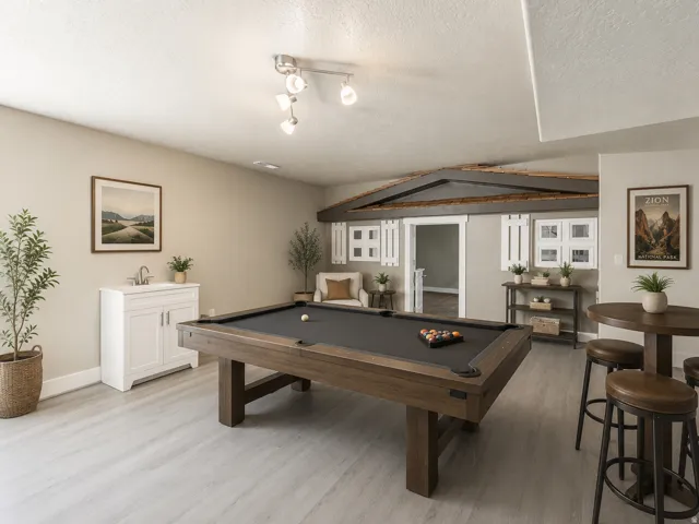 Spacious recreation room featuring wood-finish flooring, a built-in wet bar with white cabinetry, and recessed lighting