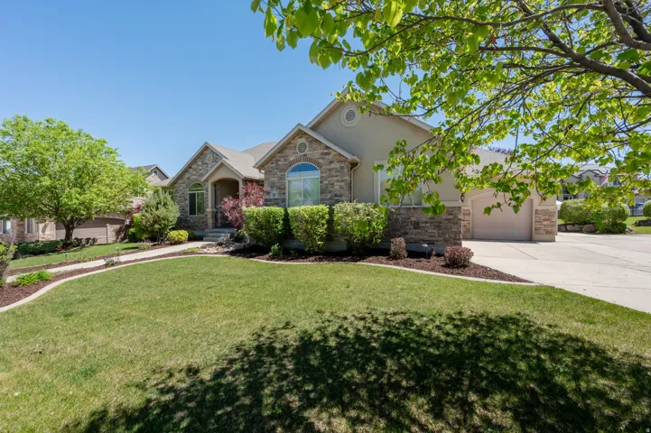 Stone and stucco exterior with multiple gables and a prominent arched window