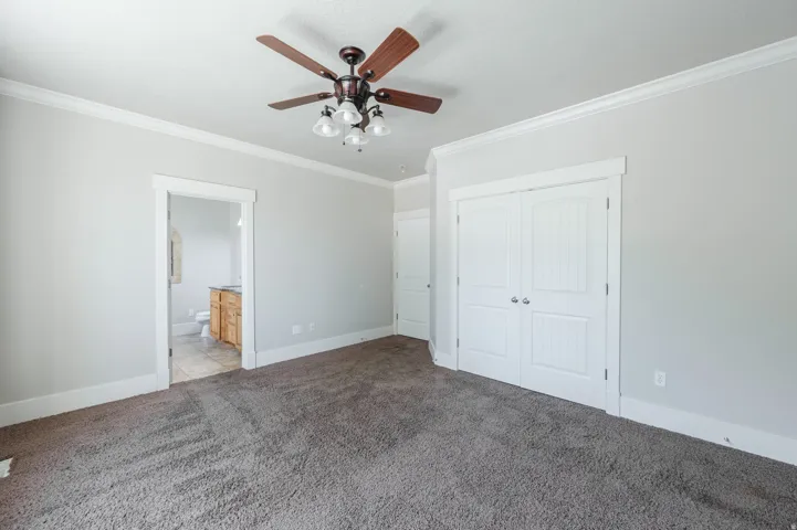 Spacious room featuring neutral carpeting and light-toned walls