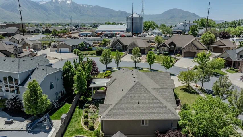 Neighborhood setting with extensive mature landscaping, paved street, and varied architectural styles