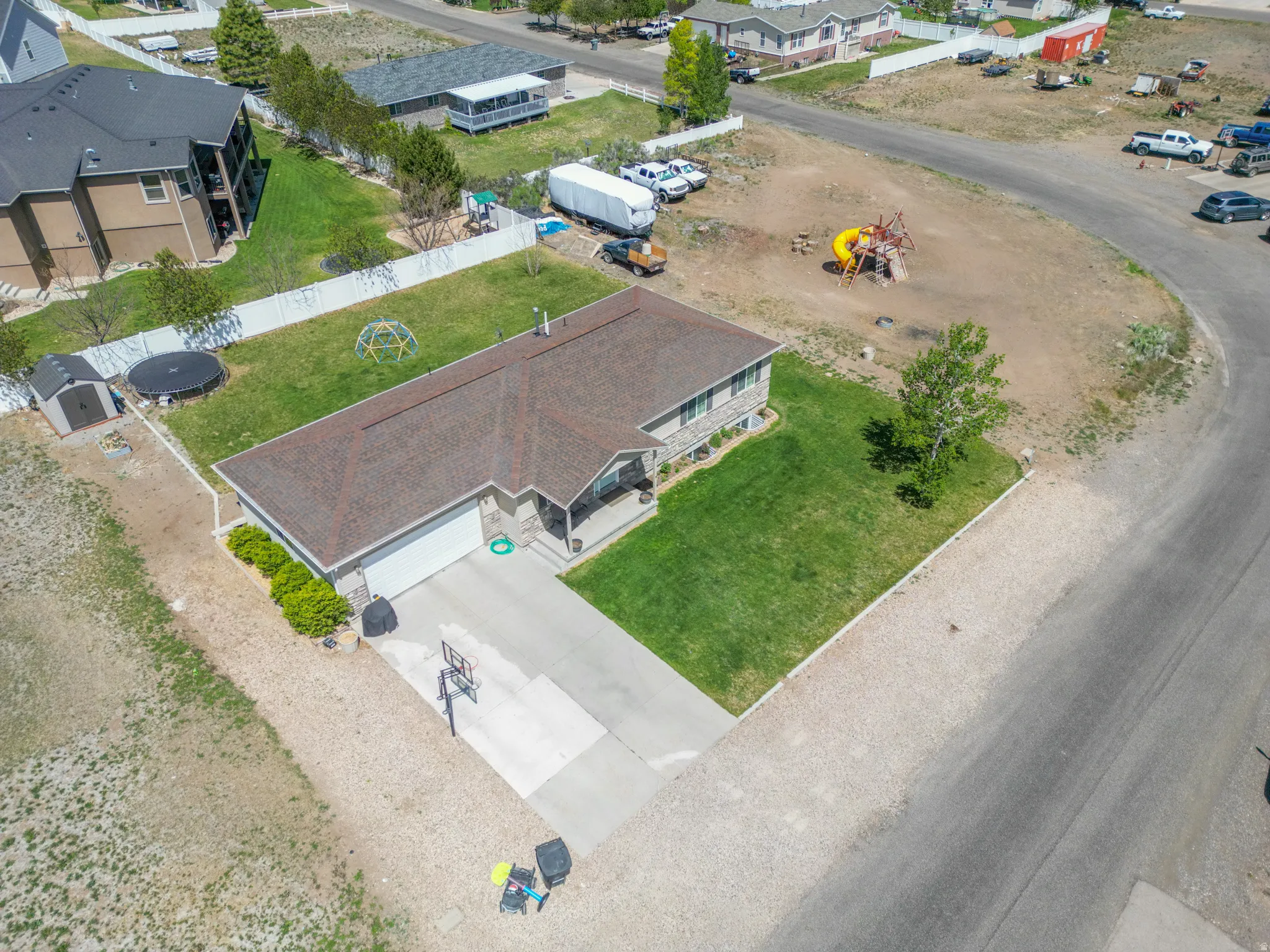 Single-story residence featuring a brown shingle roof and a concrete driveway