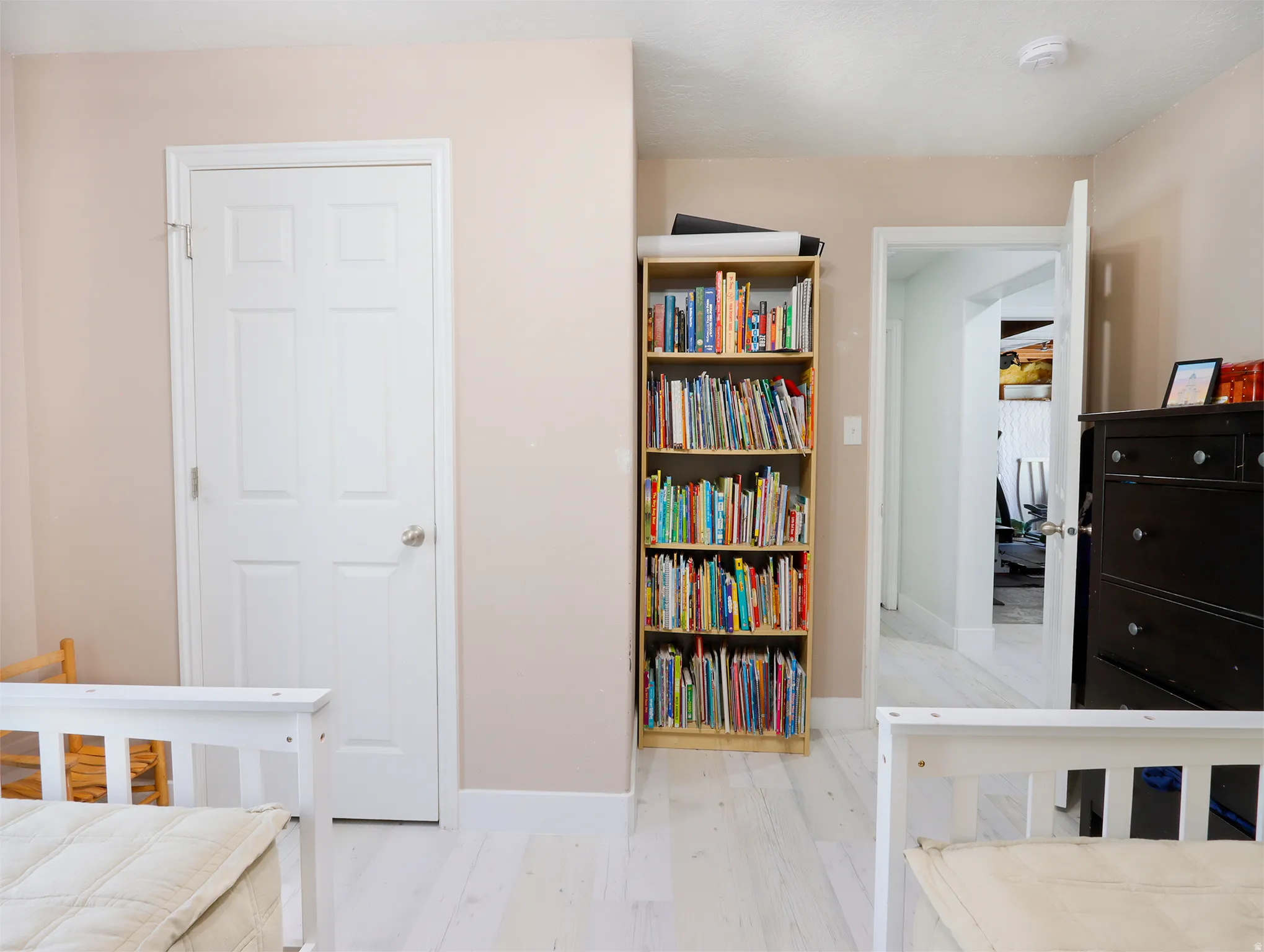 Neutral tone walls frame a white paneled door