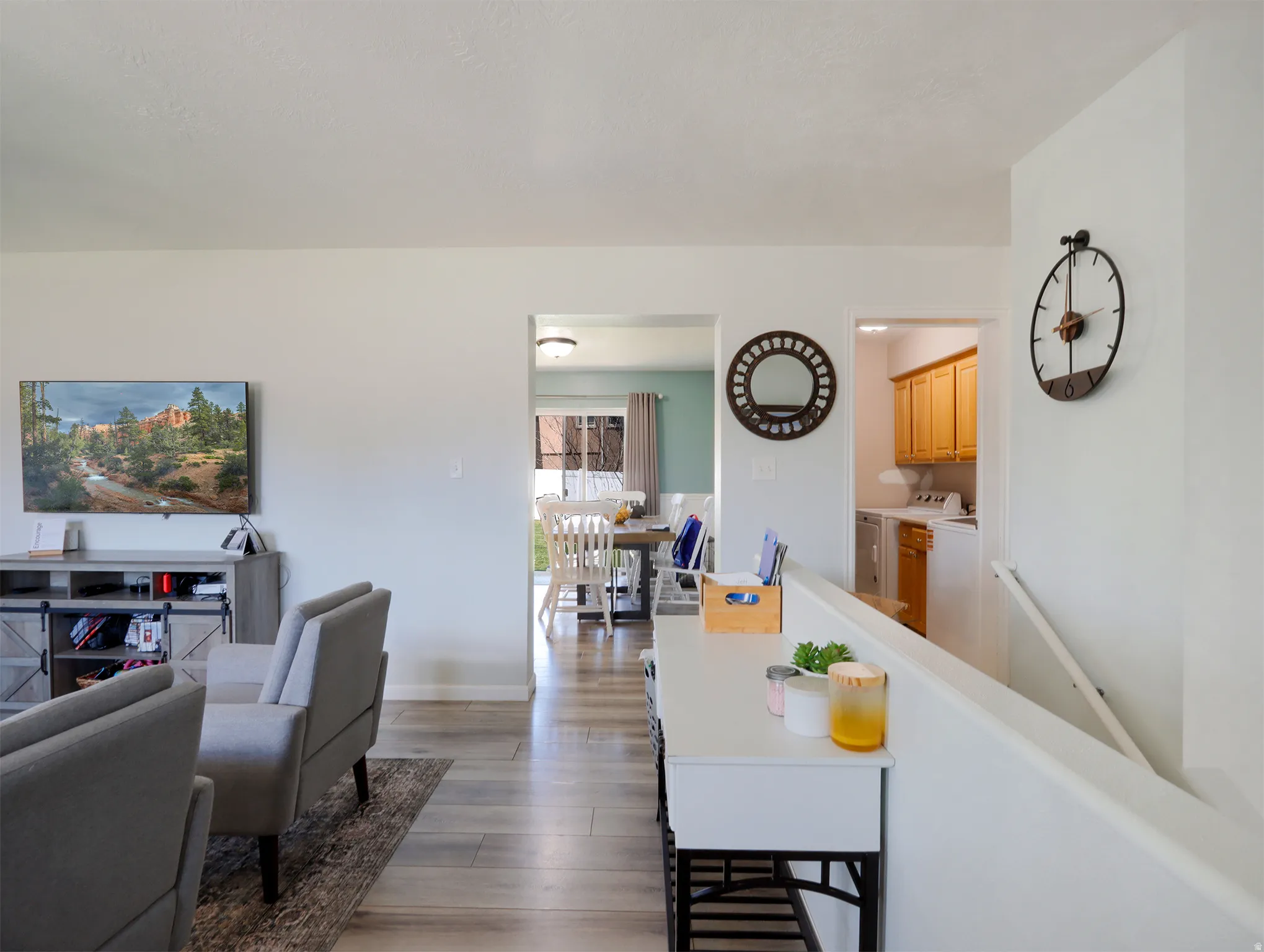 Open-concept living space featuring wood-finish flooring and light-toned walls