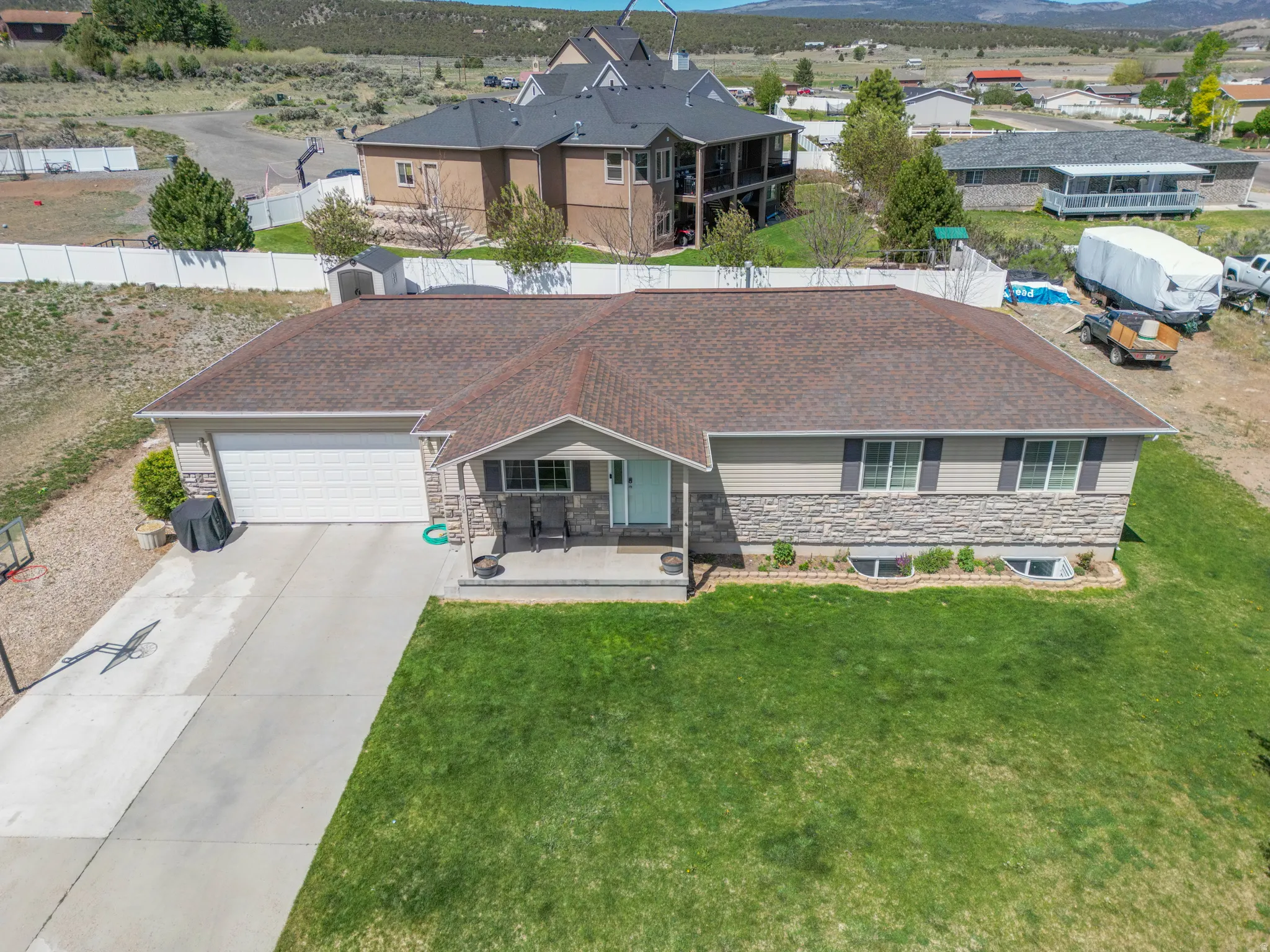 Single-story residence featuring a two-car garage, concrete driveway, and a covered front porch