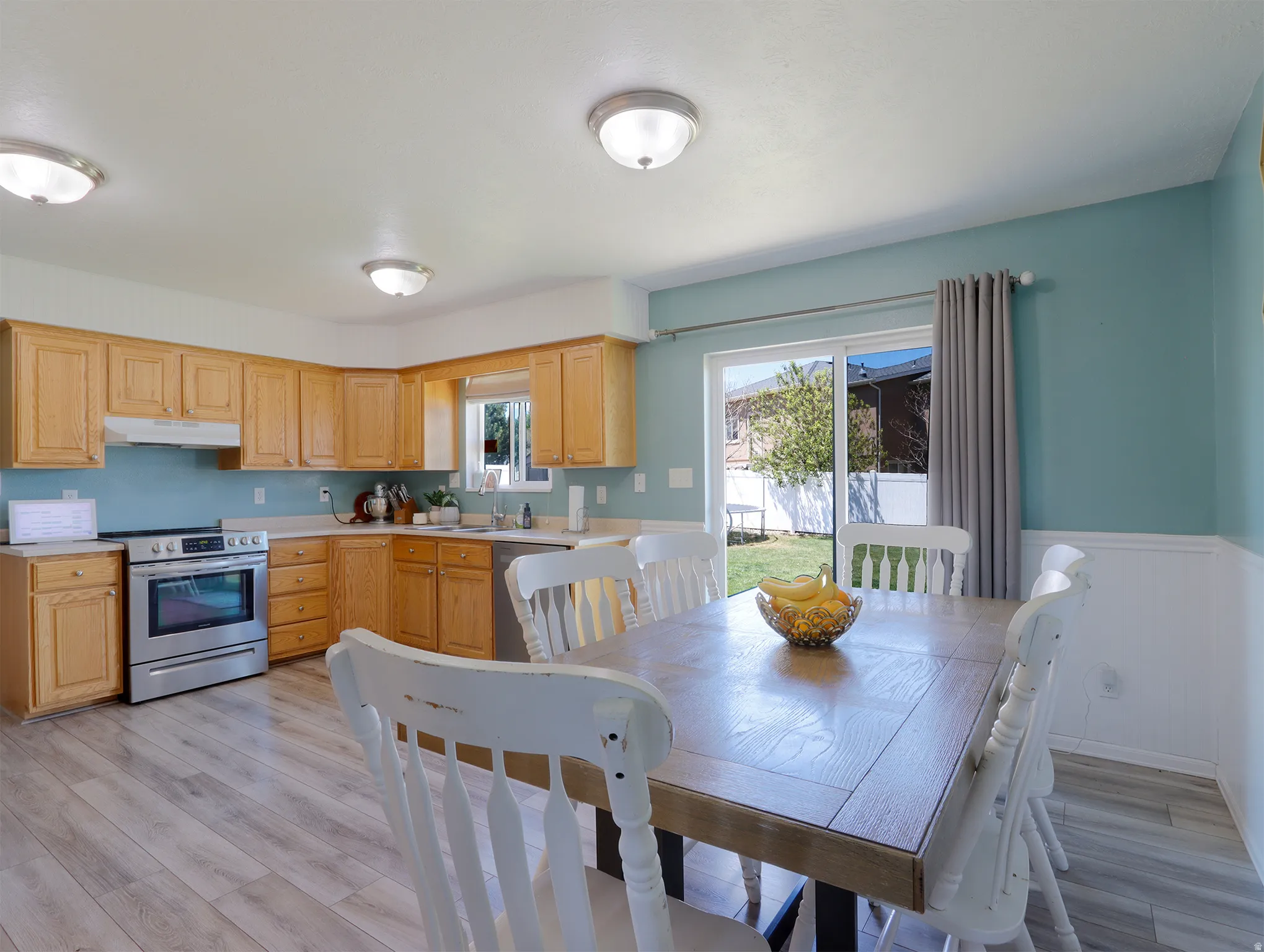 Kitchen and dining area featuring wood-finish flooring