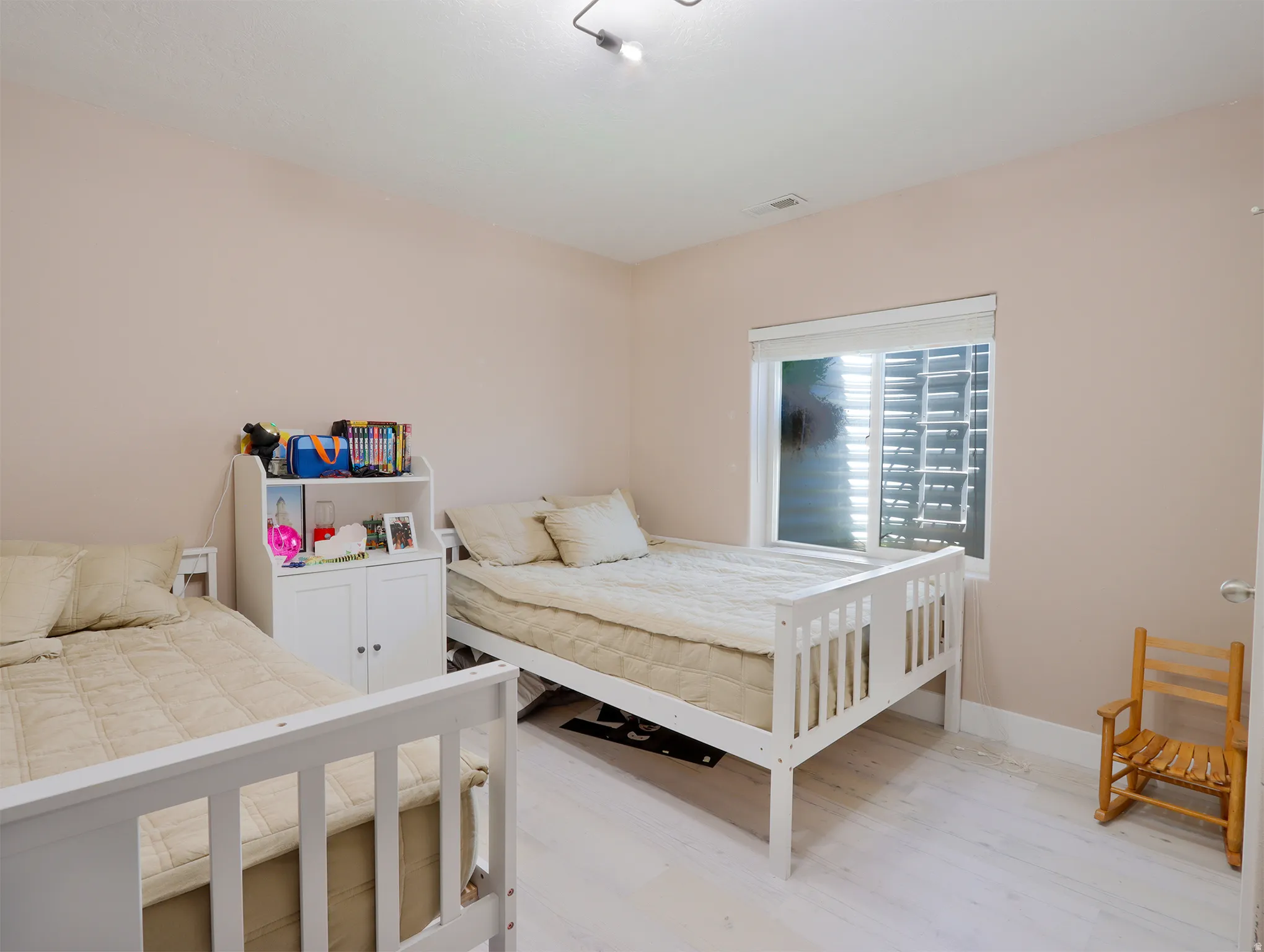 Room with light-toned walls and wood-finish flooring