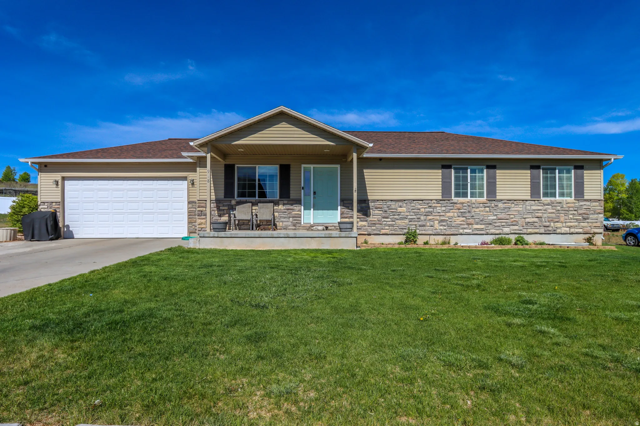 Single-story property featuring a stone and siding facade