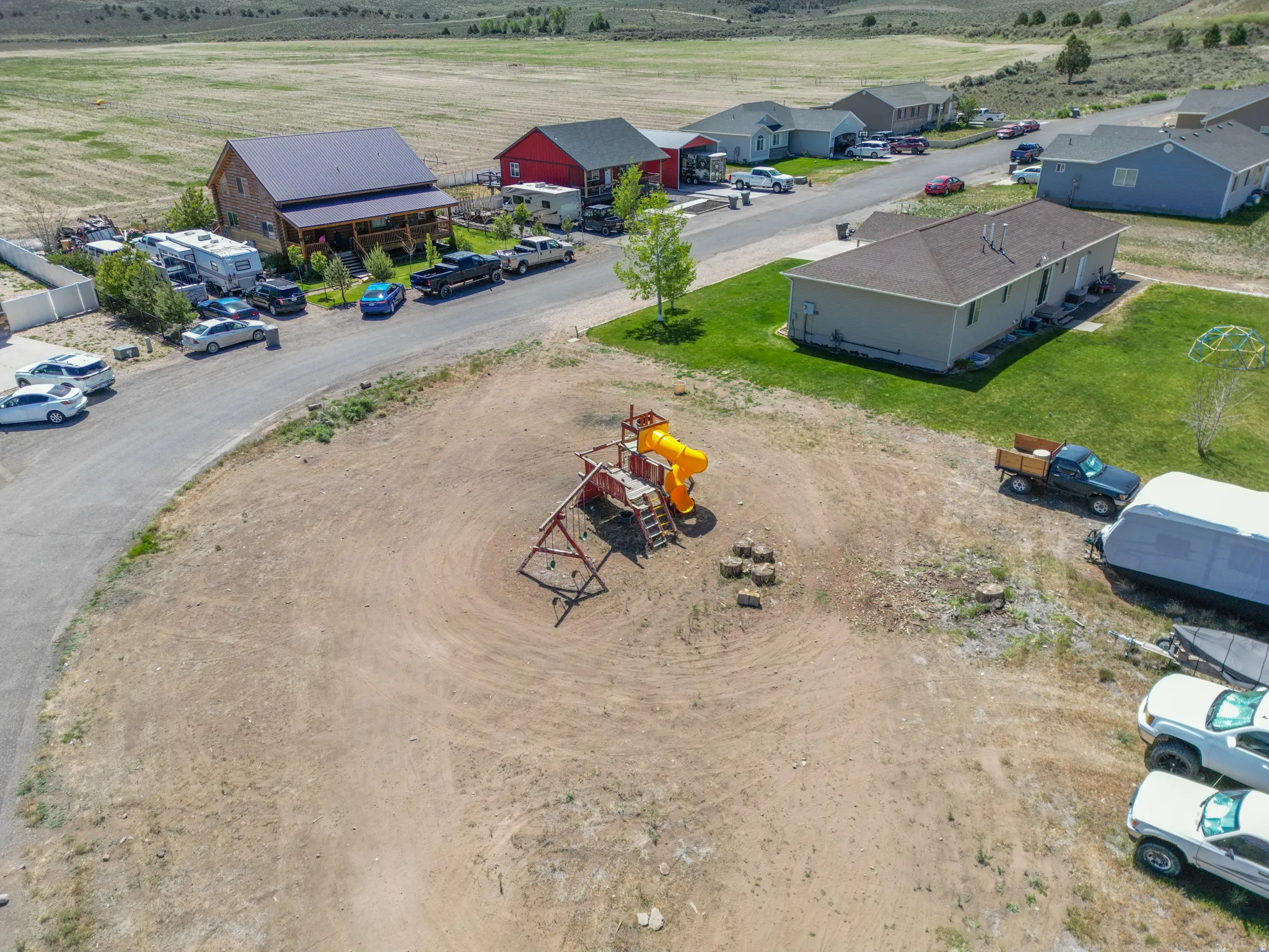 Expansive cleared lot featuring a playground structure and partial road frontage