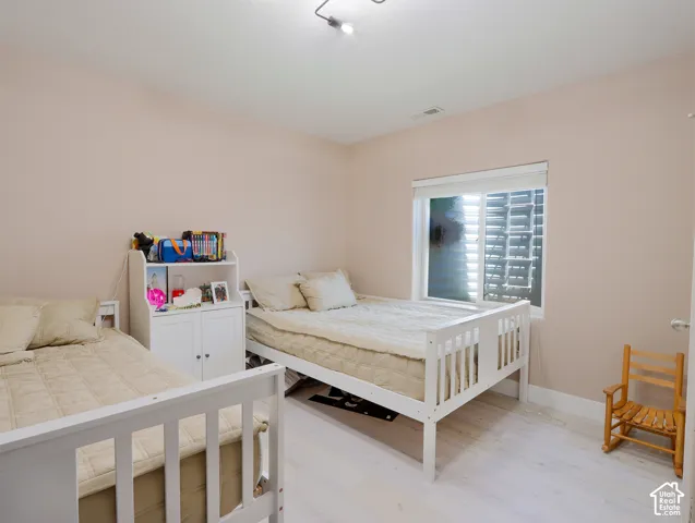 Room with light-toned walls and wood-finish flooring