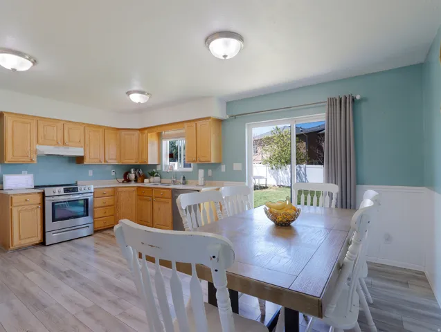 Kitchen and dining area featuring wood-finish flooring