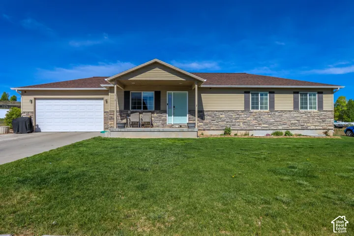 Single-story property featuring a stone and siding facade