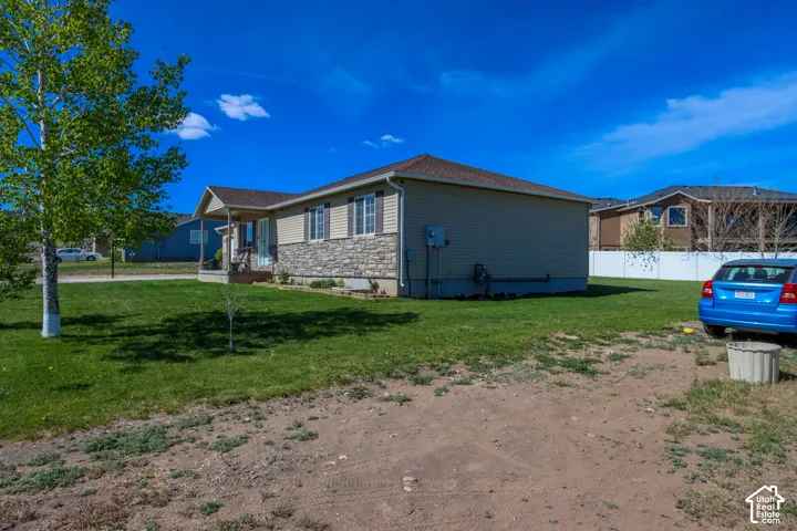 Ranch-style exterior featuring a covered front porch, stone fa