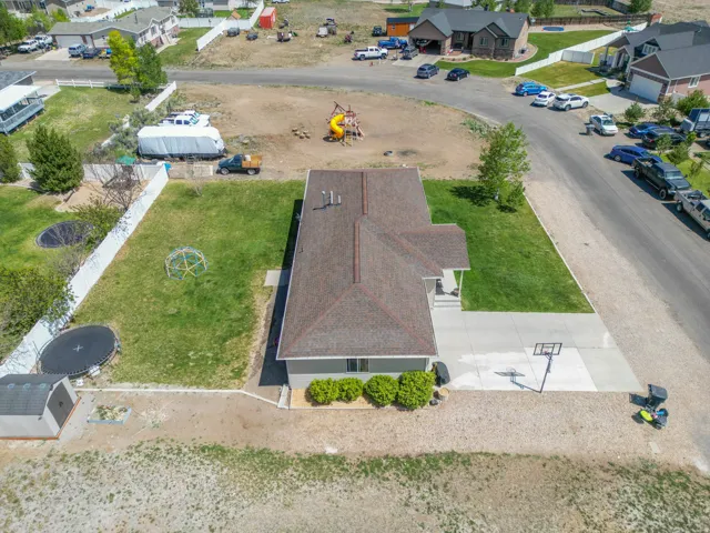 Single-story residence featuring a covered front porch, concrete driveway, and a basketball hoop