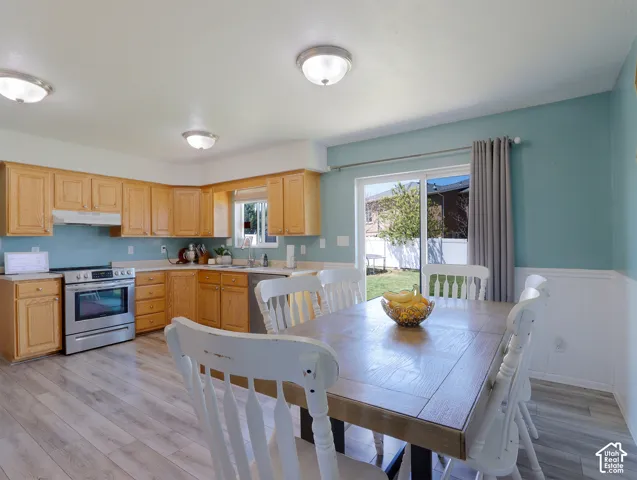 Kitchen and dining area featuring wood-finish flooring