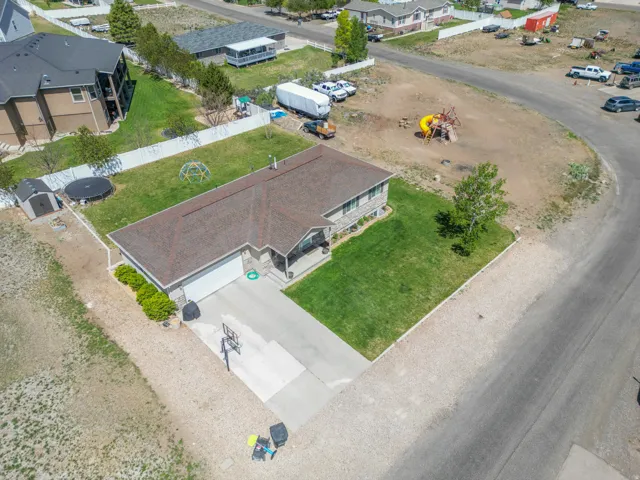 Single-story residence featuring a brown shingle roof, attached garage, and a concrete driveway