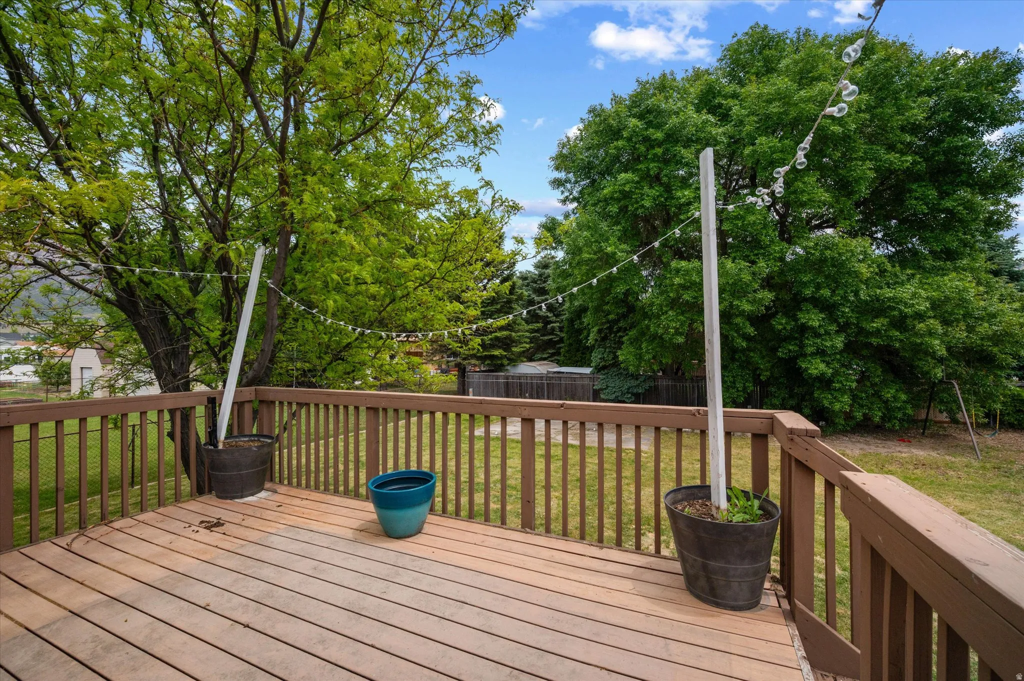 Expansive outdoor deck with natural wood-tone decking and coordinating railings and outdoor lighting