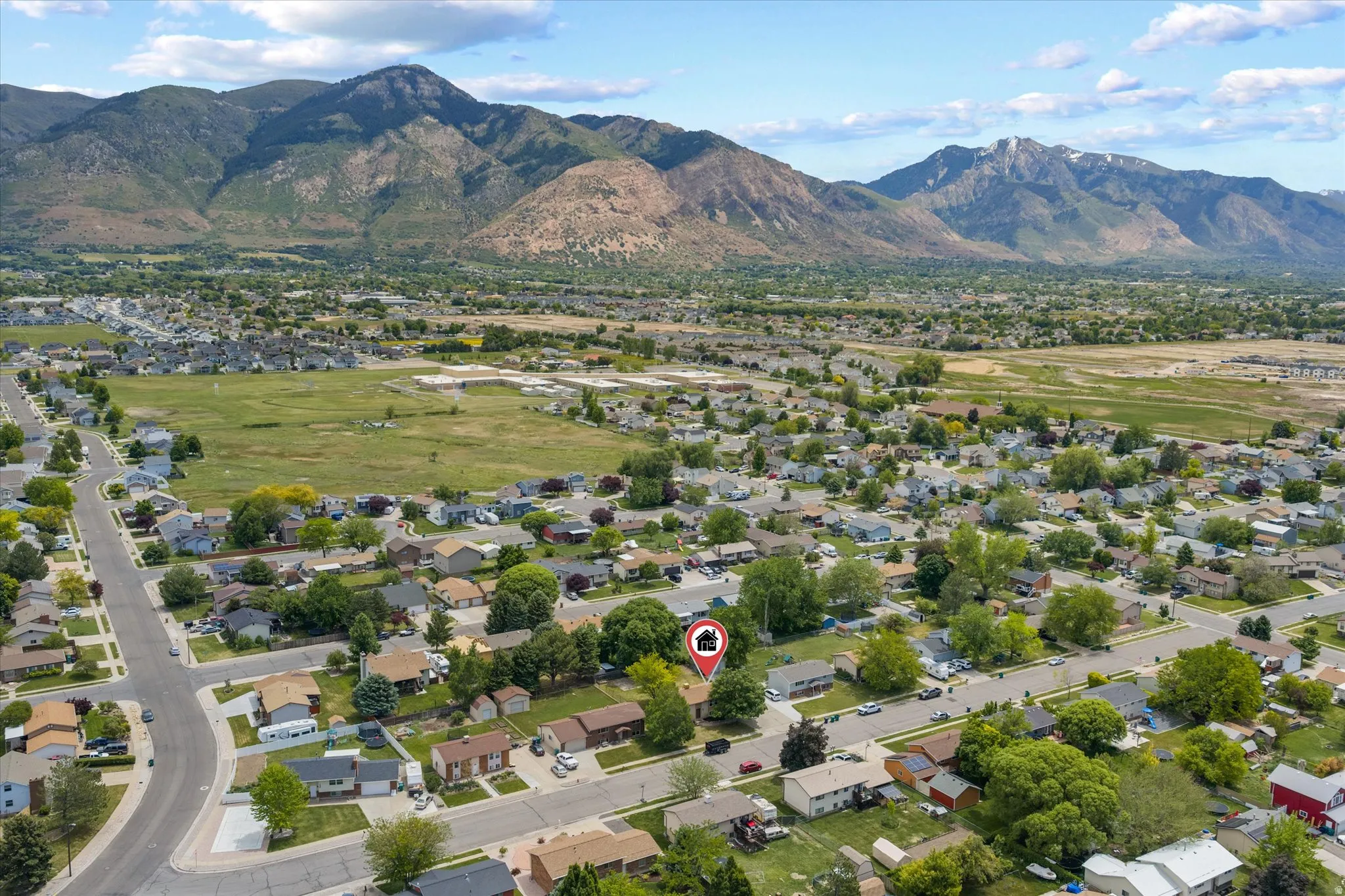 Aerial perspective showcasing a residential neighborhood with distant mountain scenery