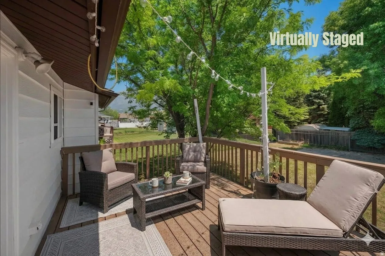 Hardwood deck featuring wood railing and a mountain backdrop