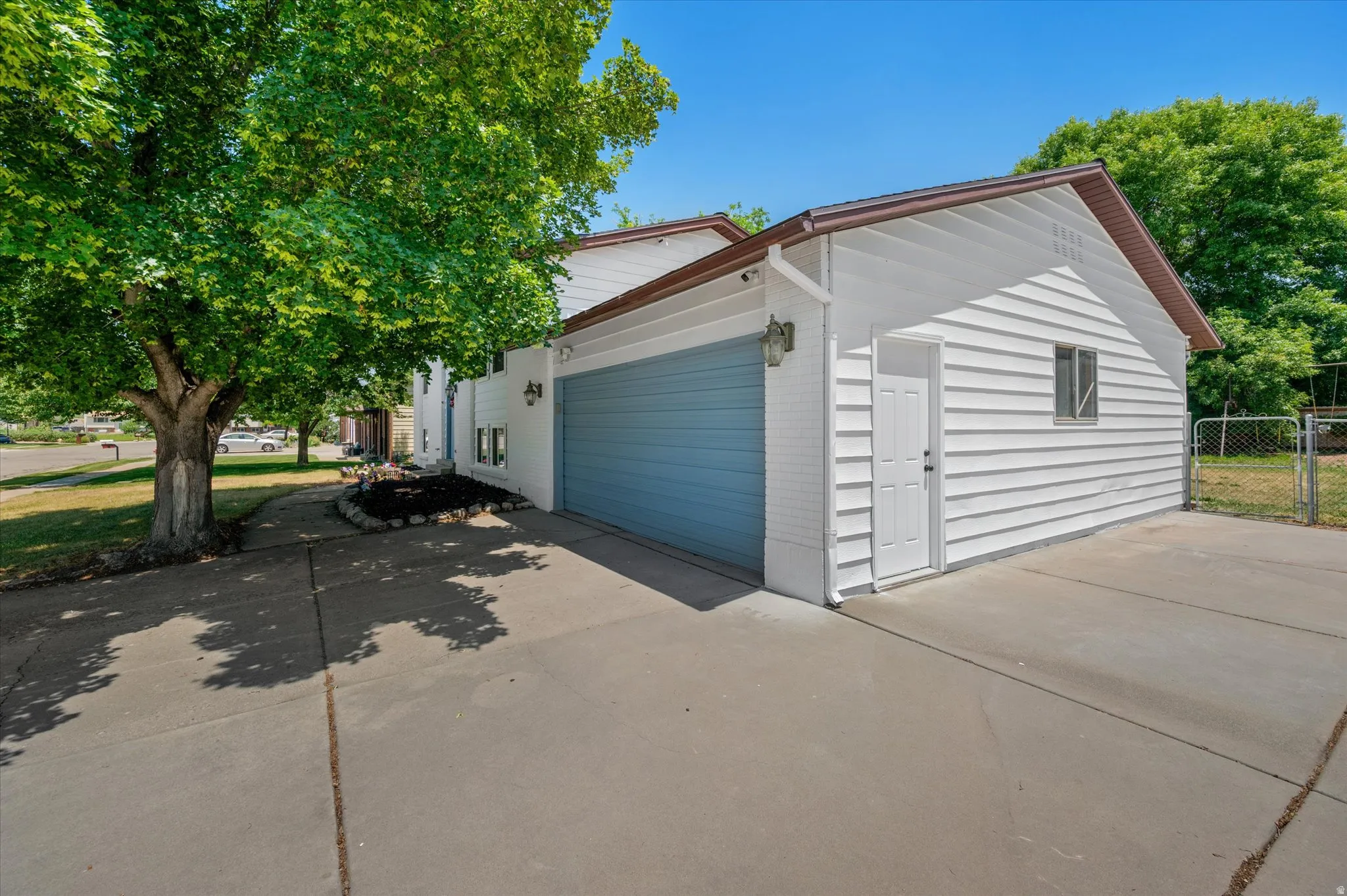 Attached two-car garage with a light blue door