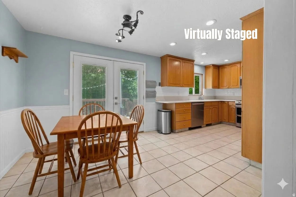 Kitchen featuring light wood cabinetry, stainless steel appliances, and tile flooring