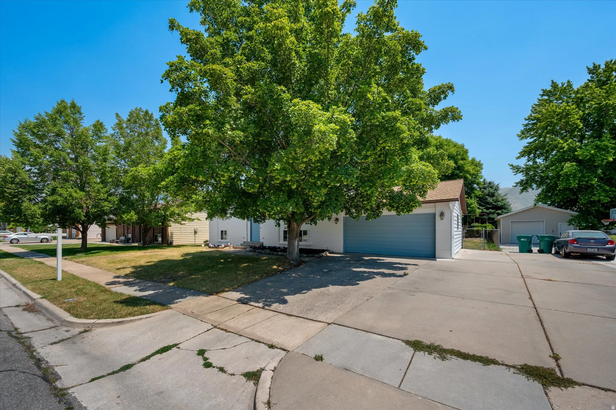 Concrete driveway providing access to a two-car garage and RV pad