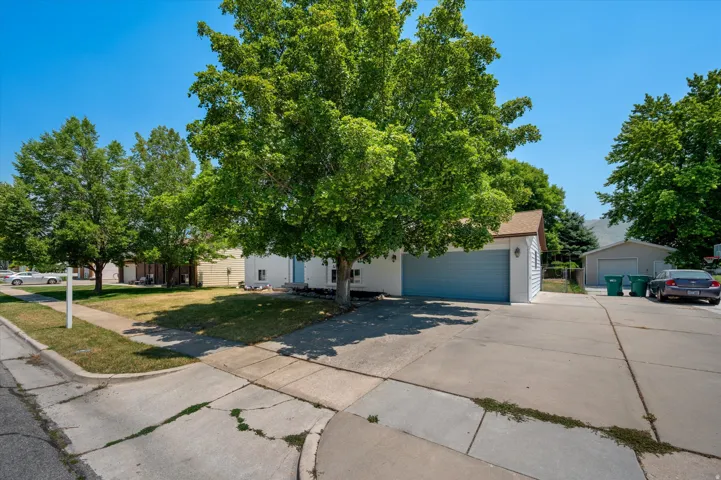 Concrete driveway providing access to a two-car garage and RV pad