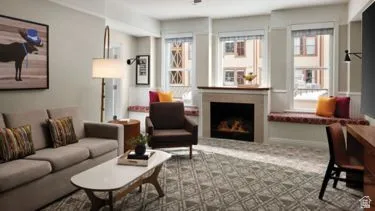 Living area with a built-in fireplace featuring a stone surround and wood mantel