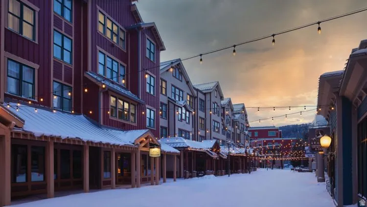 Commercial storefronts featuring pitched roofs, exposed beams, and string lighting