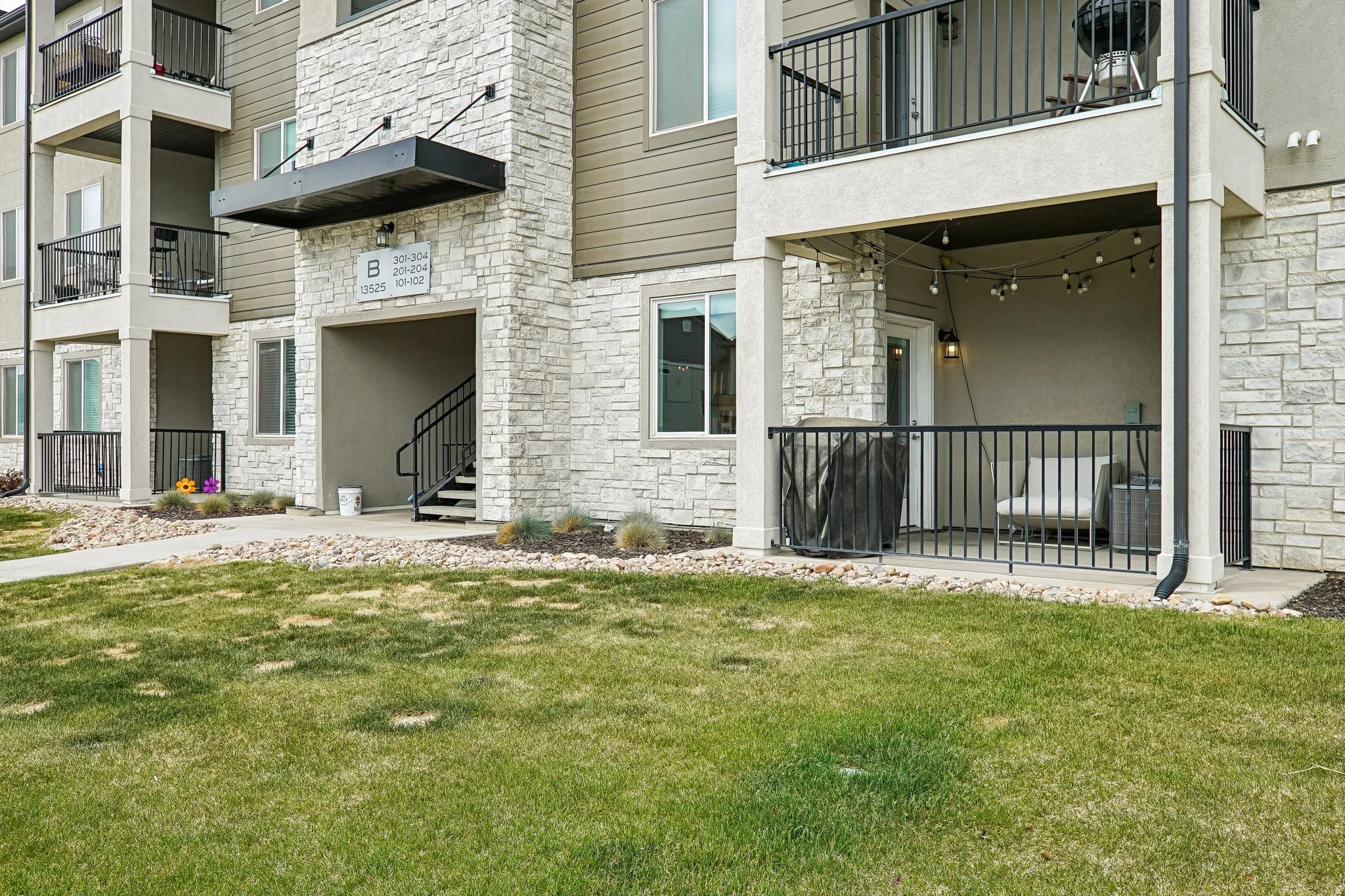 Stone veneer and siding exterior with a covered entry
