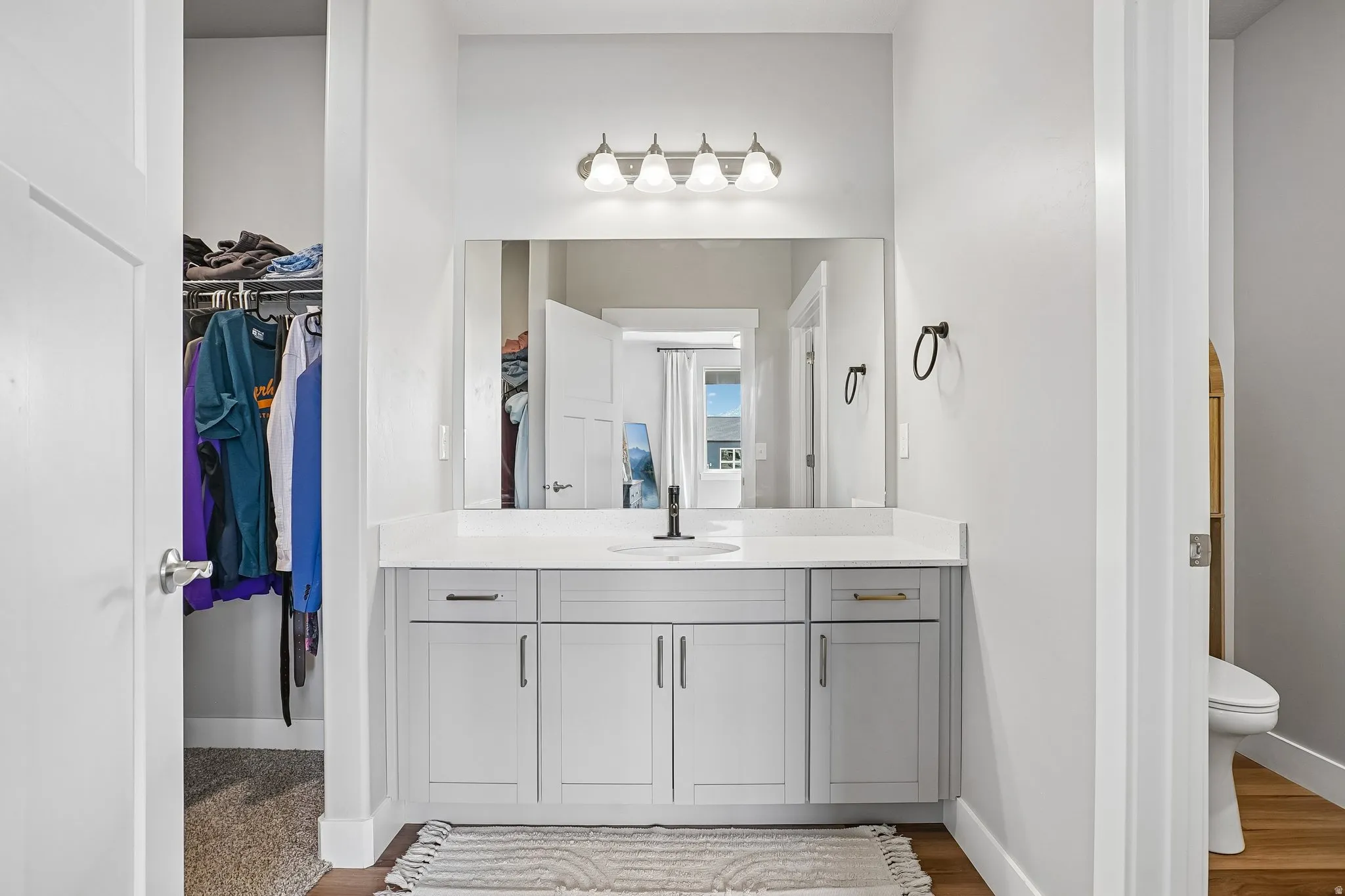 Floating light gray vanity with a white countertop and rectangular undermount sink