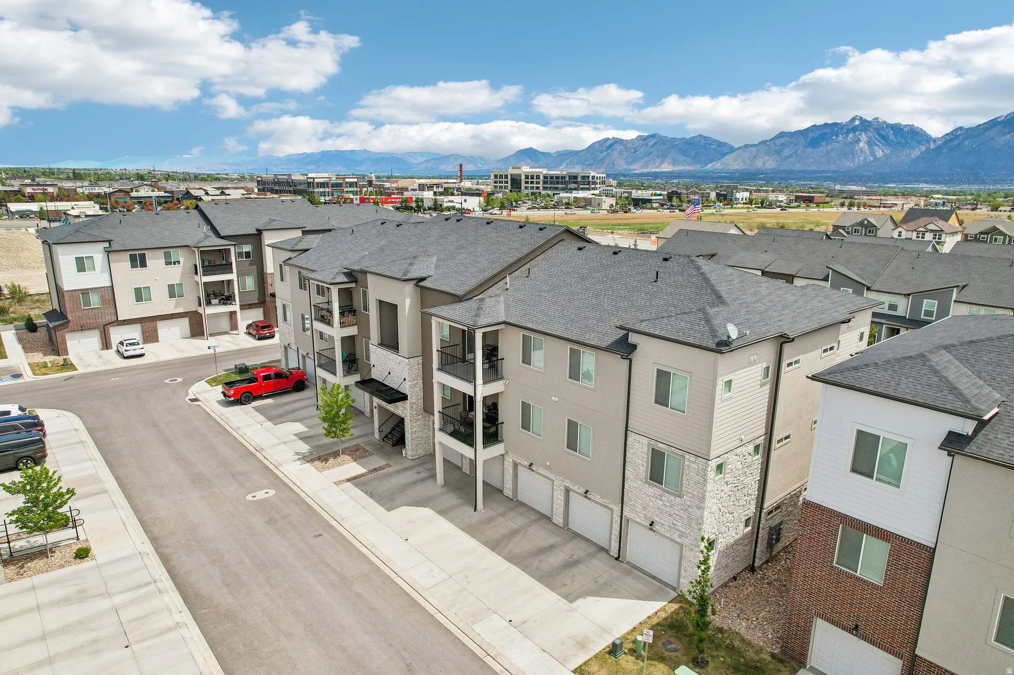 Contemporary multi-story apartment building with a mountain backdrop