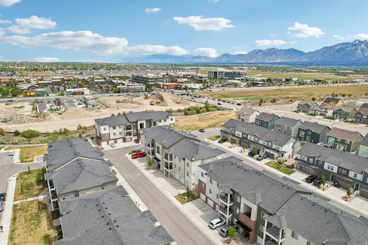 Expansive aerial view showcasing residential properties with a mix of townhomes and multi-story buildings