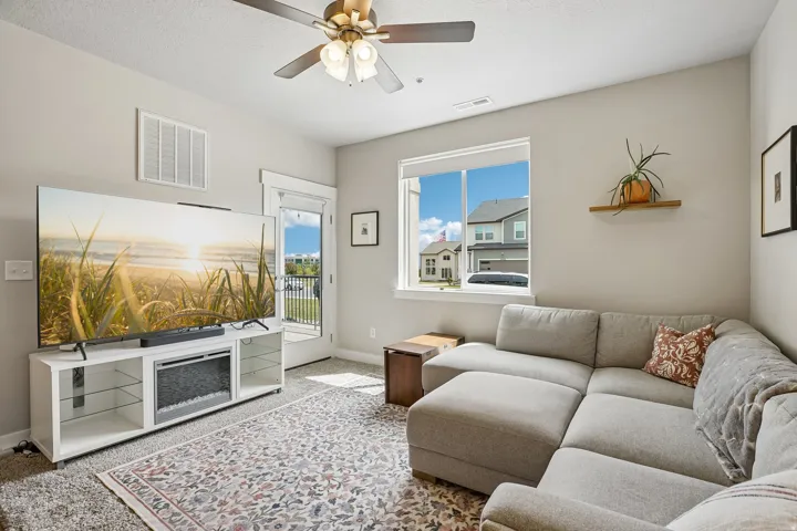 Living space featuring a ceiling fan, recessed lighting, and a neutral color palette