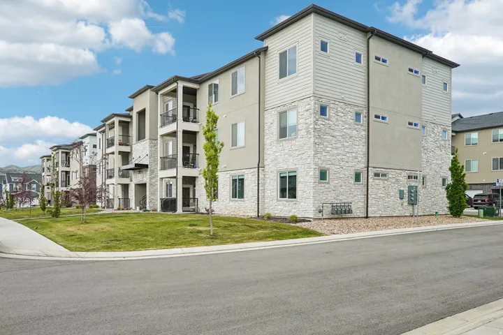 Contemporary multi-story building featuring light-colored stone veneer and stucco siding