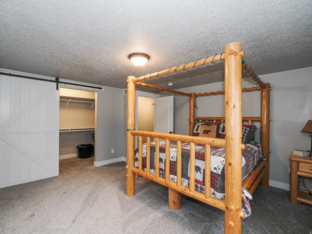 Plush carpeted flooring complements the light gray wall paint