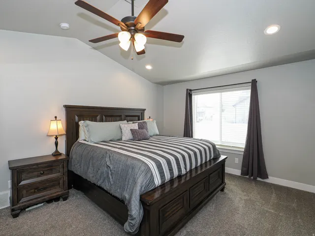 Vaulted ceiling featuring a ceiling fan with light fixture and recessed lighting