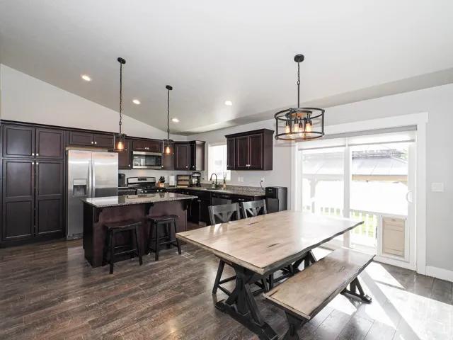 Open-concept kitchen and dining area with vaulted ceilings