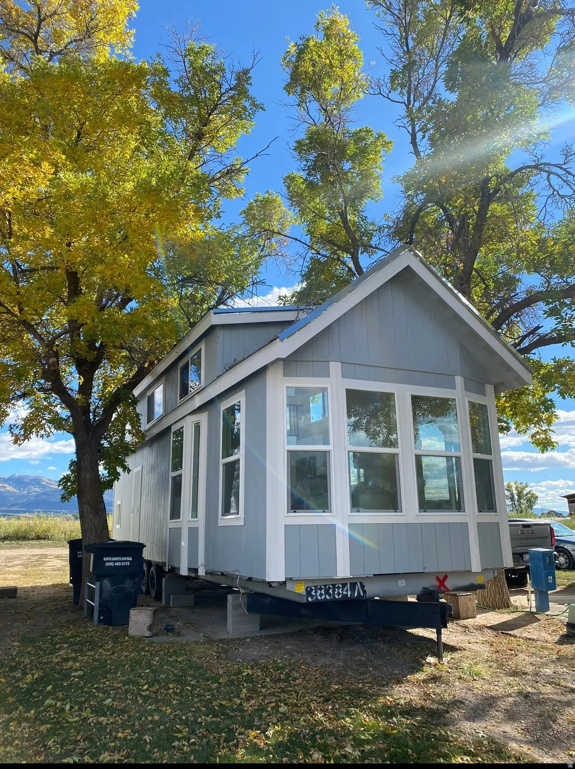 Light blue siding home featuring a prominent bay window with multiple panes