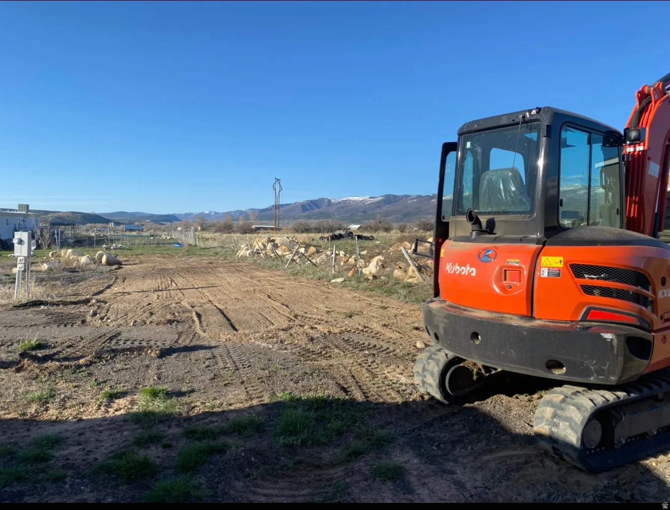 Expansive lot featuring a graded dirt surface and distant mountain scenery