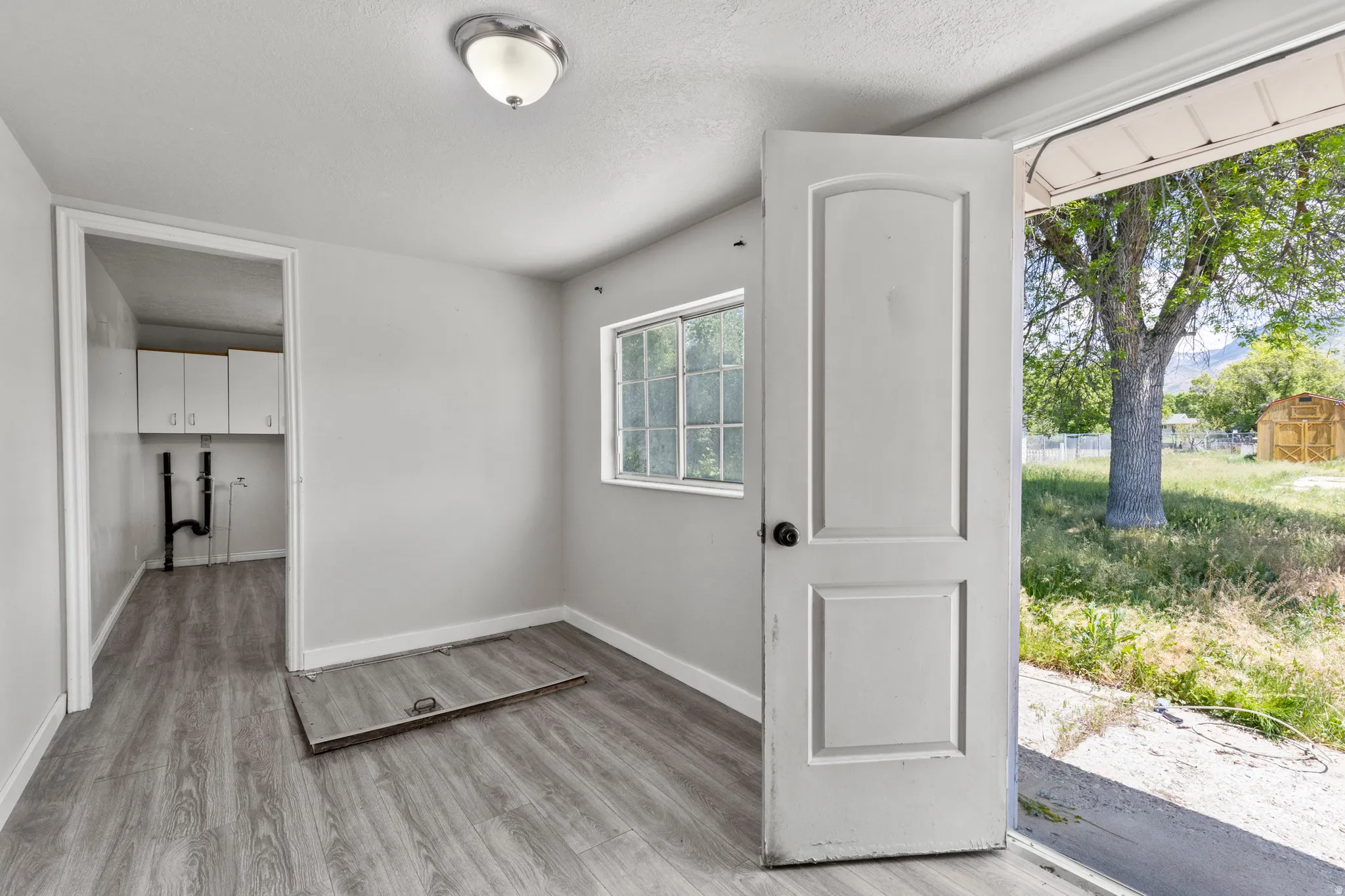 HUG mud room and more pantry space/storage.  The trap door is the access to the 624 sq. ft. basement that unfinished.  You could even have a work station/desk here.