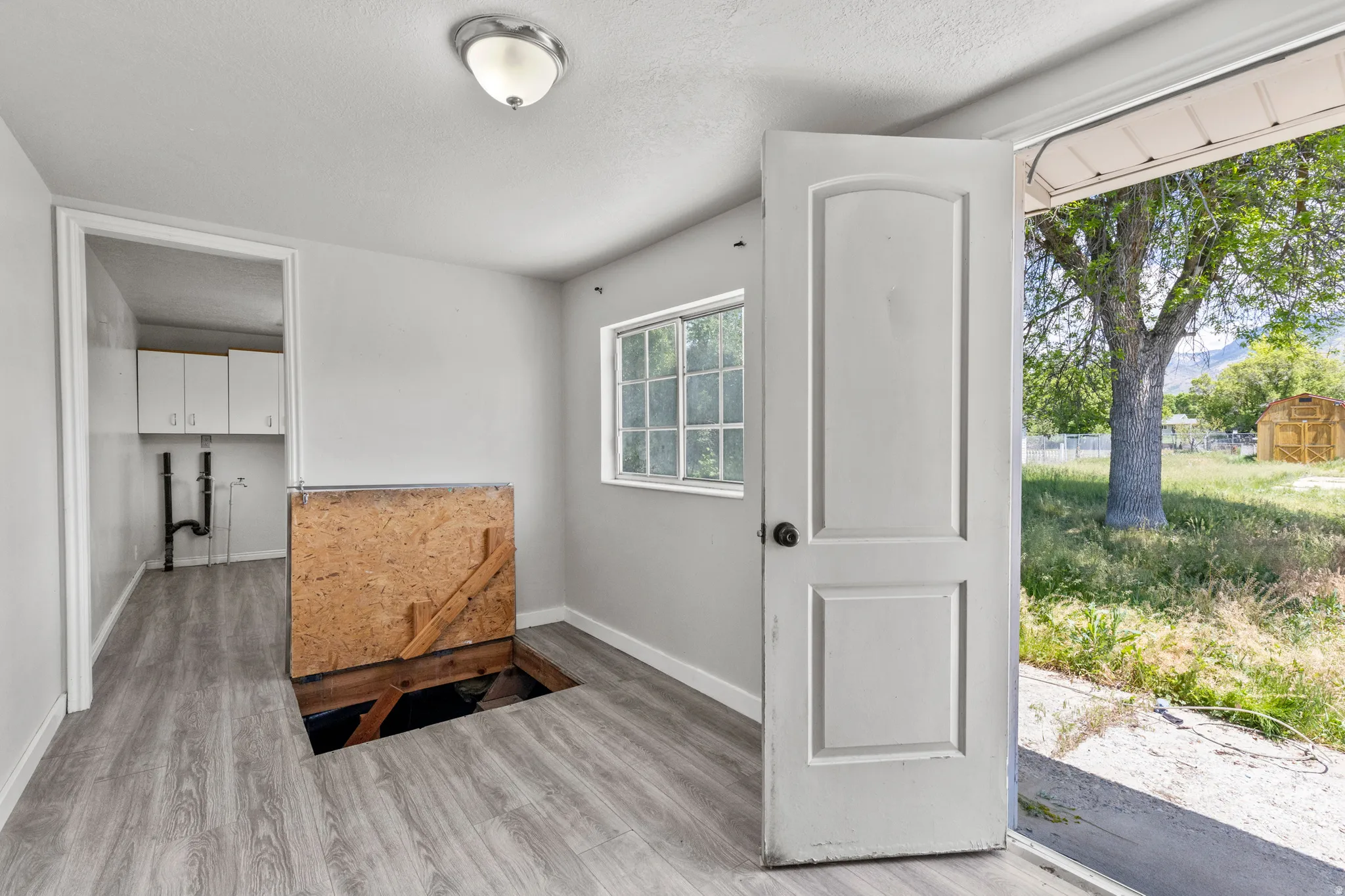 Trap door open to show the ability to put a stair case with a railing if you finish the basement.